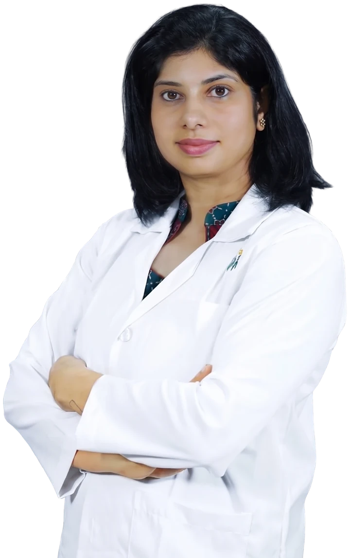 Dr. Neema Bhat in a white coat, arms folded, smiling